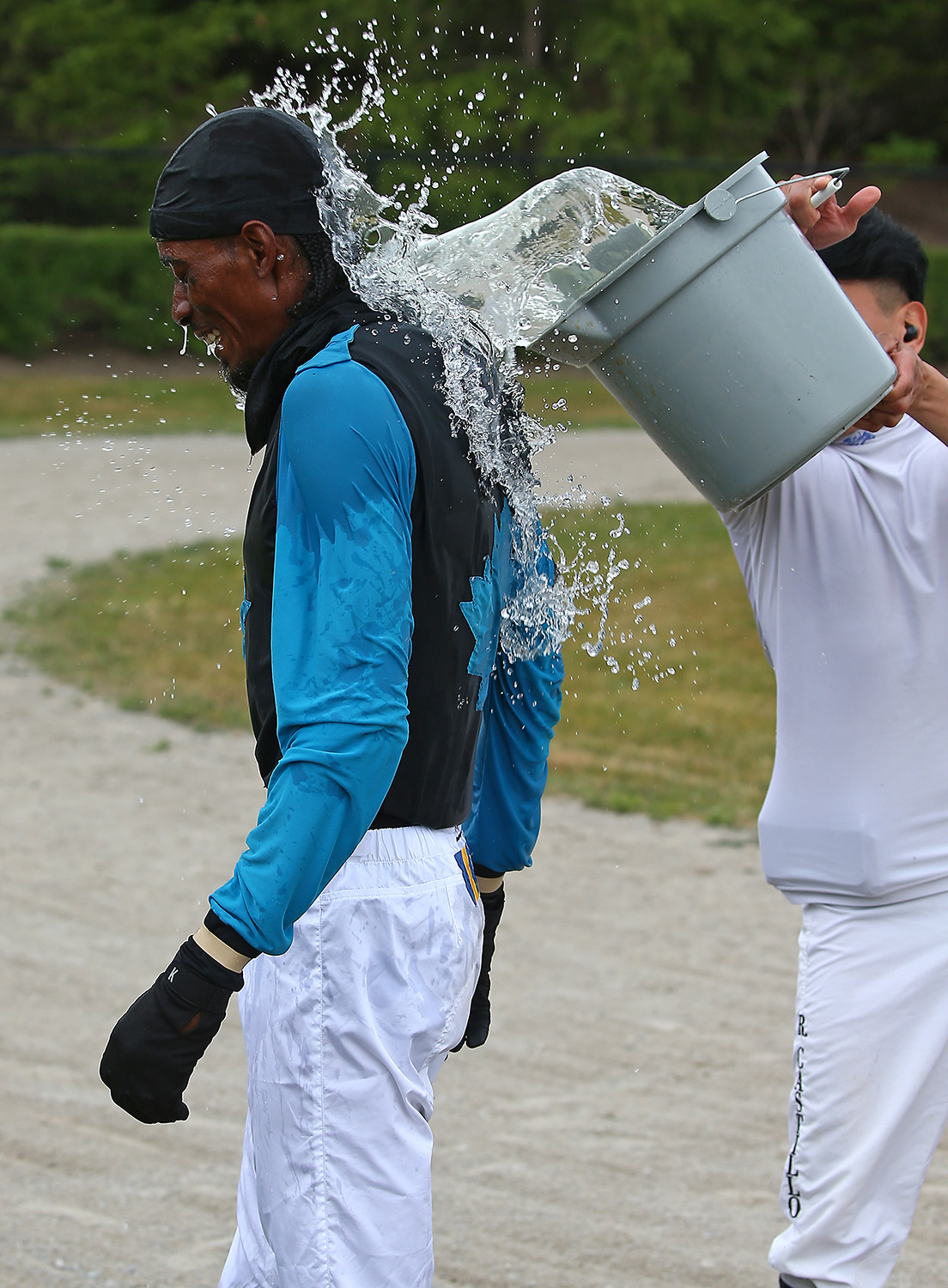 Jockey gets water dumped on him, which is tradition after first win.