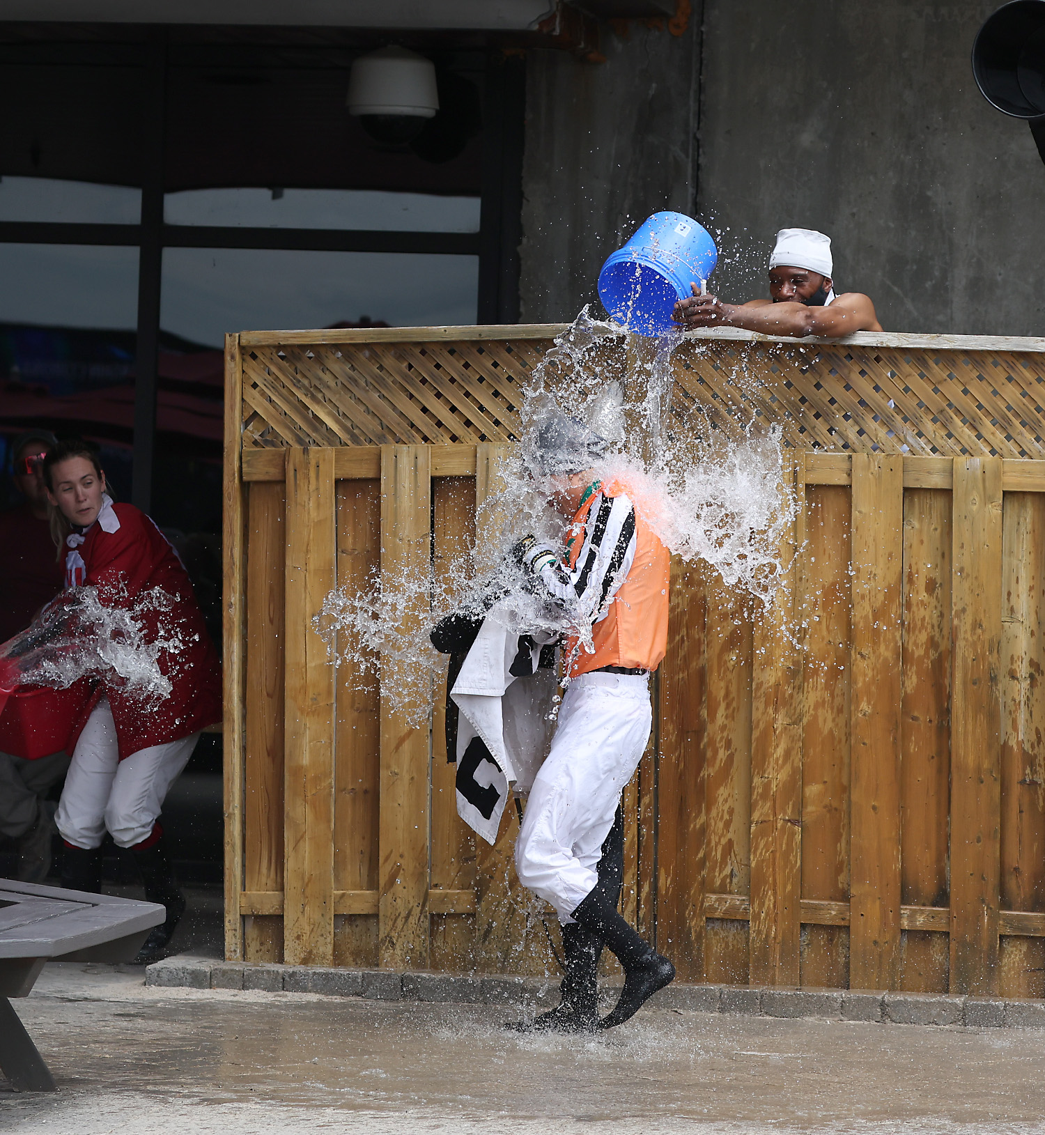 As is customary when a rider wins his first race, Alexis Sanchez is doused with water by his fellow riders. (New Image Media).