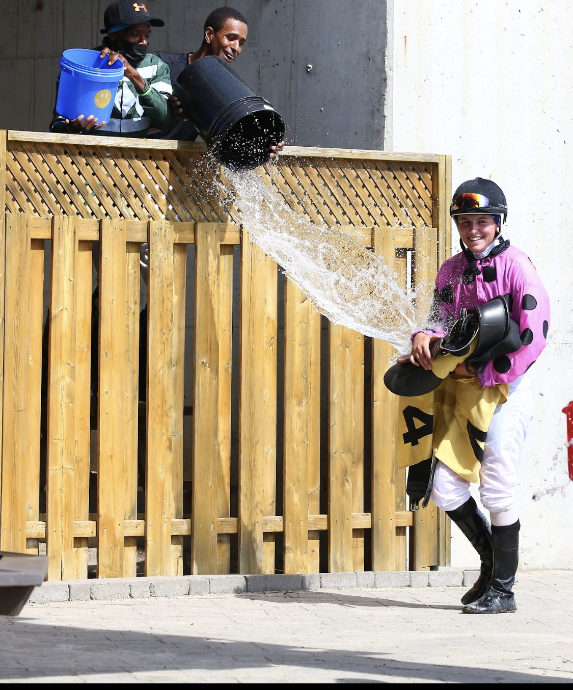 Cheyenne Kerr is dunked with water by veteran riders Tony Phillips and Neil Husbands following her first career win.