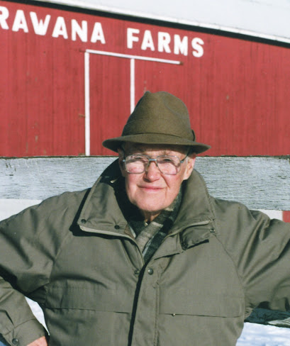 Lloyd Chisholm, one of the original promoters of the OSS, stands in front of his iconic red barn bearing the name “Arawana Farms,” located not far from Mohawk.