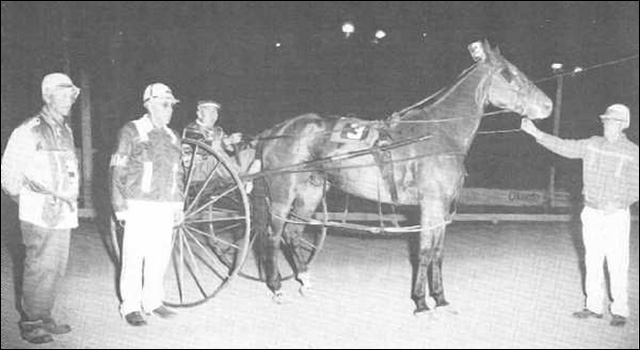 From the left are Elmer Fritz, Hugh McLean, Jacob Geisel (seated in the high wheeler) and Frank Carnahan holding the horse.