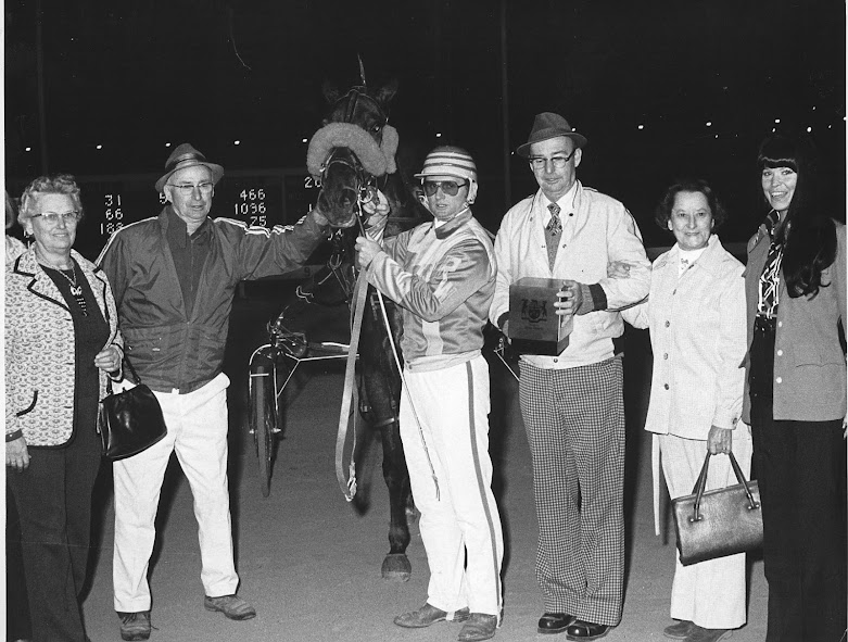 Merrywood Susie and driver Ron Waples appear in the winner's circle in this 1975 photo joined by brother owners W.E. Spicer of Delhi, Ont., and D.R. Spicer of Otterville, Ont., and their wives.