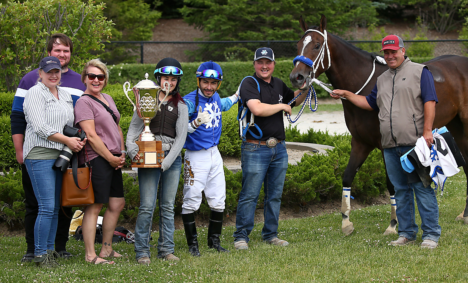 Eye Live for Candy with her winning team including owner Milena Kwiecien (far left), trainer Jason Pascoe (far right) and his daughter Jessica (holding trophy).
