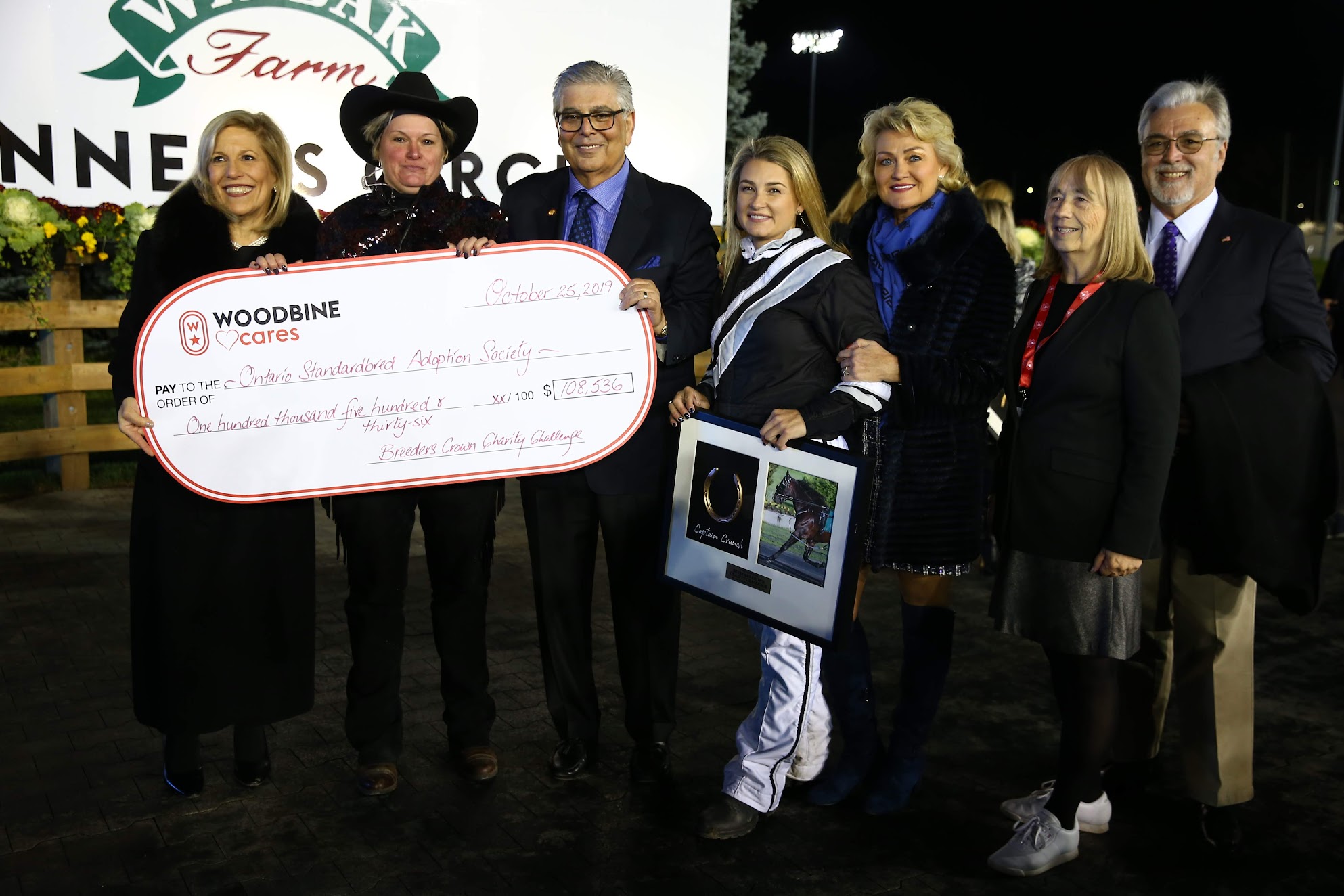 Marvin Katz (third from left) and Lynn Katz (far left) present a cheque to OSAS at the 2019 Breeders Crown Charity Challenge presentation.